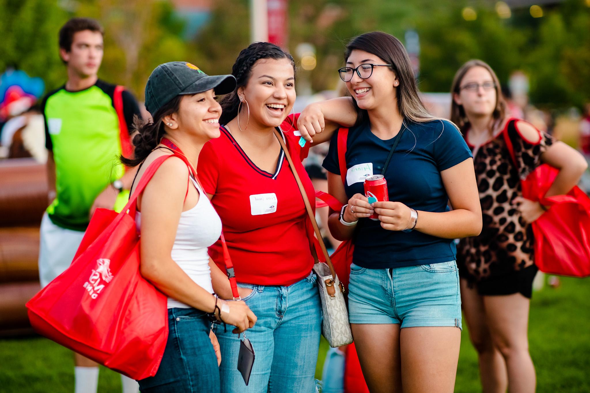 Group of students hugging and laughing