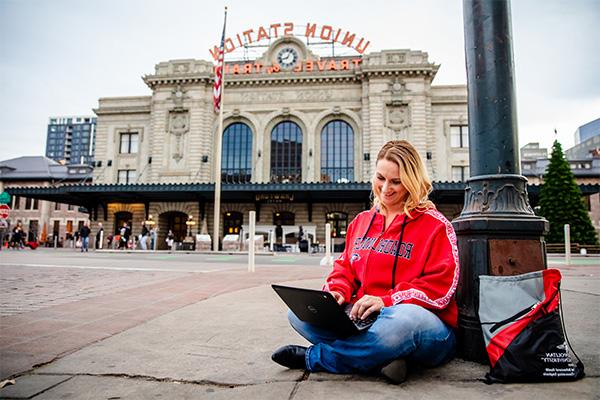 An MSU Denver student studies on her laptop outside of Union Station.