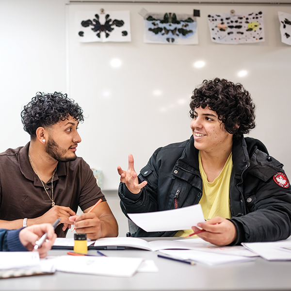 Two students talking during class