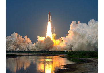 Image of a rocket launching with reflection in pond