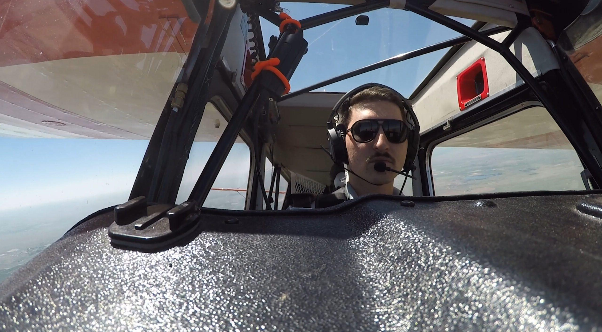 MSU Denver student in the cockpit of an aerobatics plane.